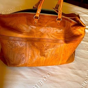 Large tooled leather duffel bag